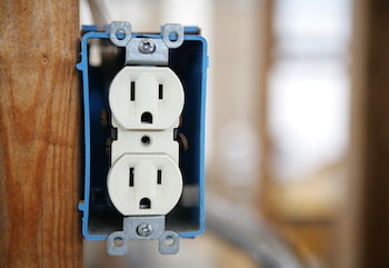 Photo of Attaboy electric fixing old outlets, a common electrical problem.